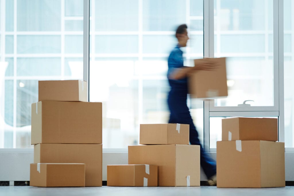 Employee moving boxes in an office space