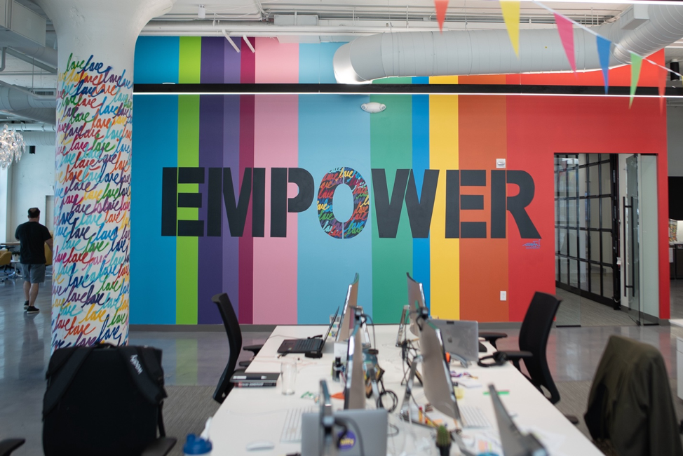 Colorful "Empower" mural at Wodify office