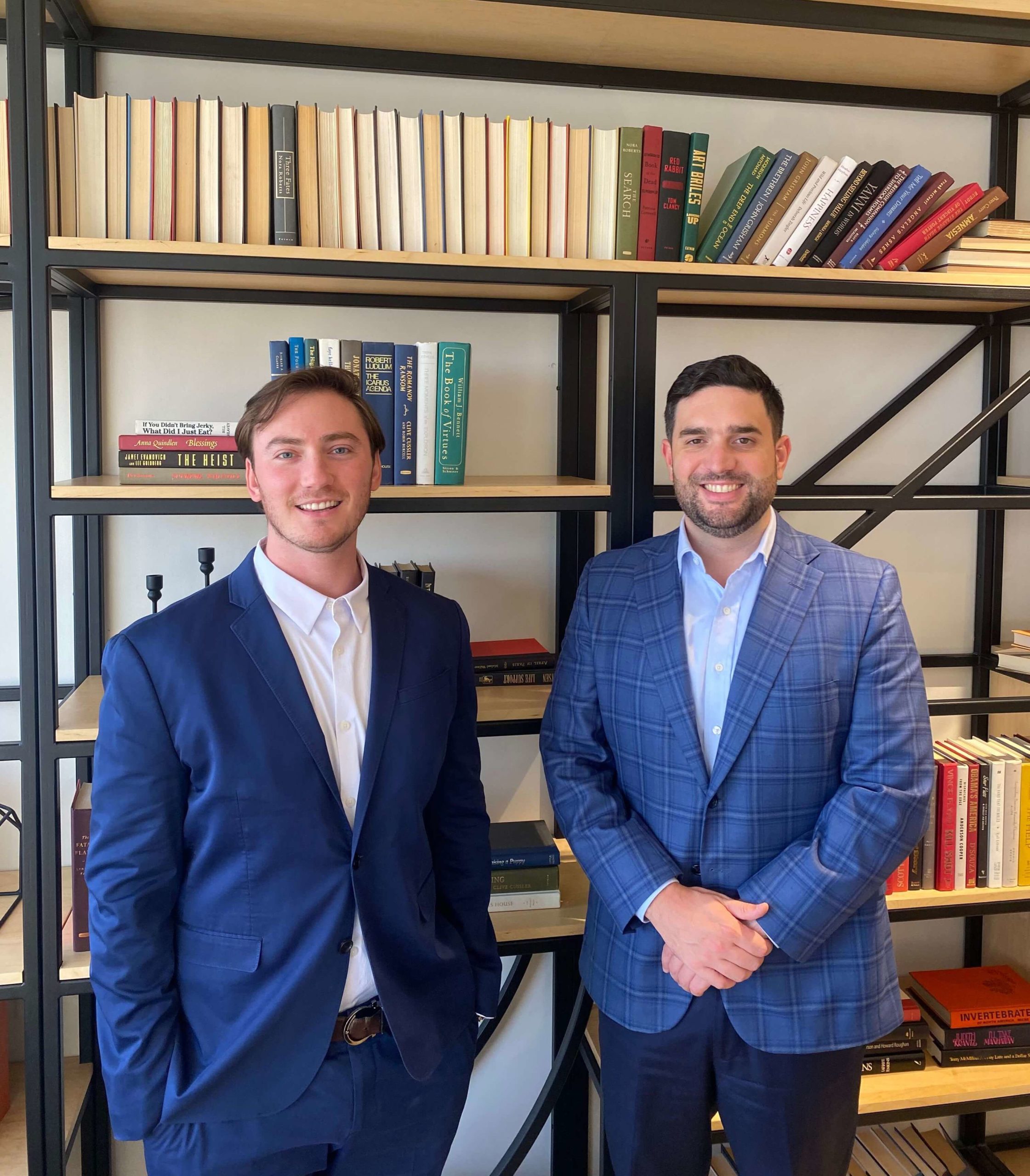 Sam Pouns and Michael Gordon standing in front of bookshelf